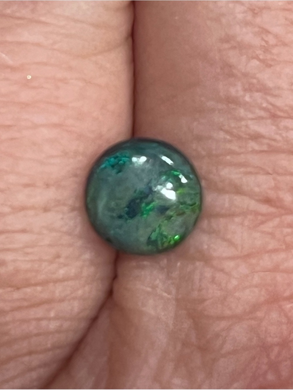 .58 carat 7mm eye-catching green iridescent black opal stone